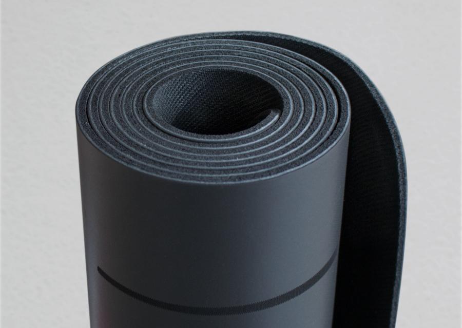 Closeup view of edge of rolled black yoga mat