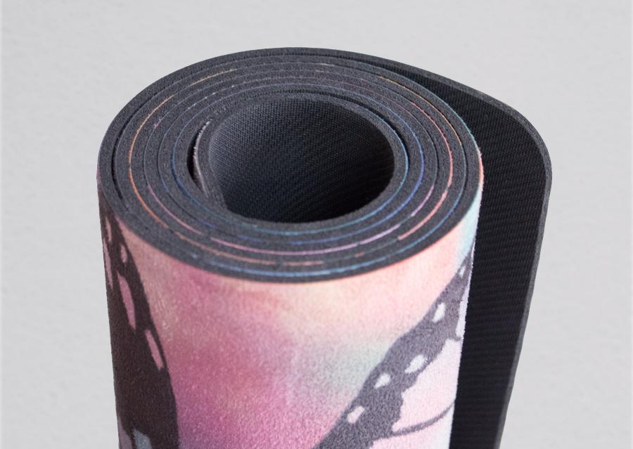 closeup view of rolled colorful butterfly themed printed yoga mat