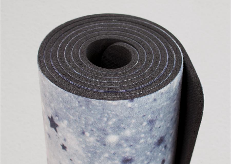 closeup view of rolled up moon cycle themed yoga mat