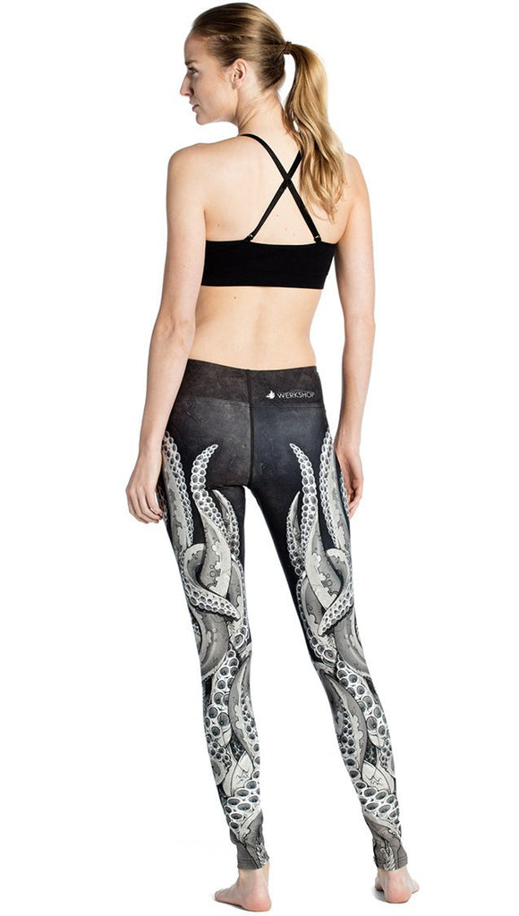 back view of model wearing black and white tentacle themed printed full length leggings