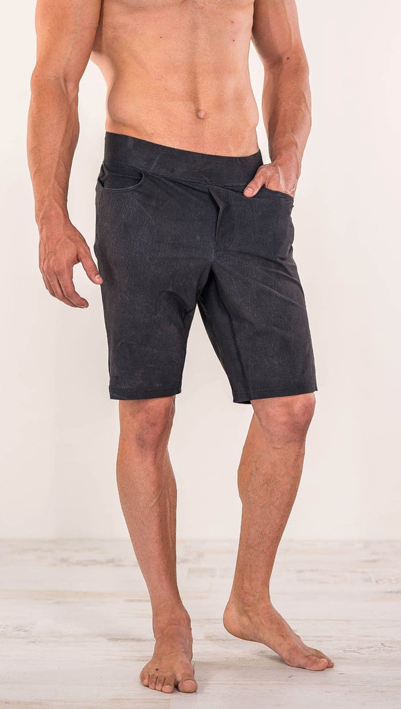 Close up front view of model wearing charcoal black printed men's performance shorts