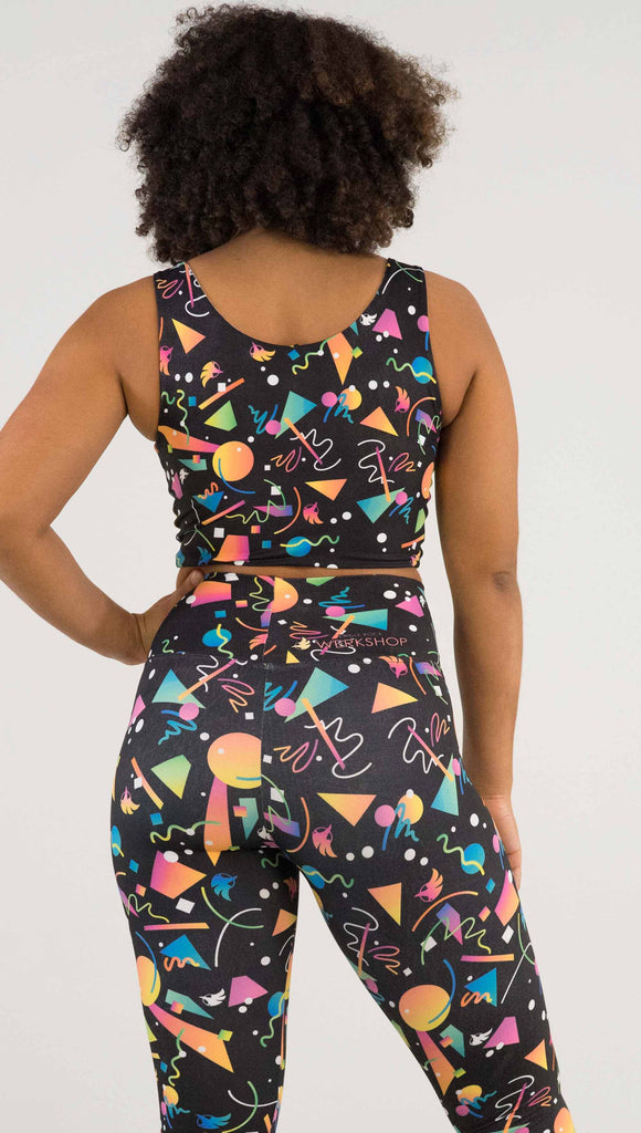 Back view of model wearing WERKSHOP Black and White Confetti Top ... with multi-colored confetti  over a black background on one side and over a white background on the other side. 