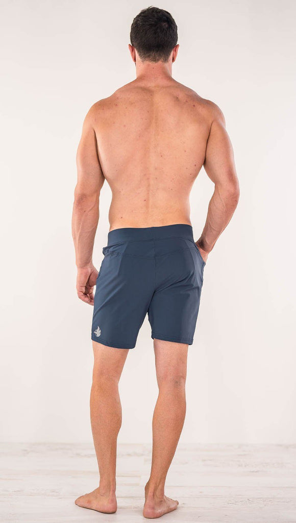 Back view of model wearing black men's performance shorts