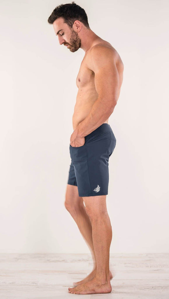 Left side view of model wearing black men's performance shorts