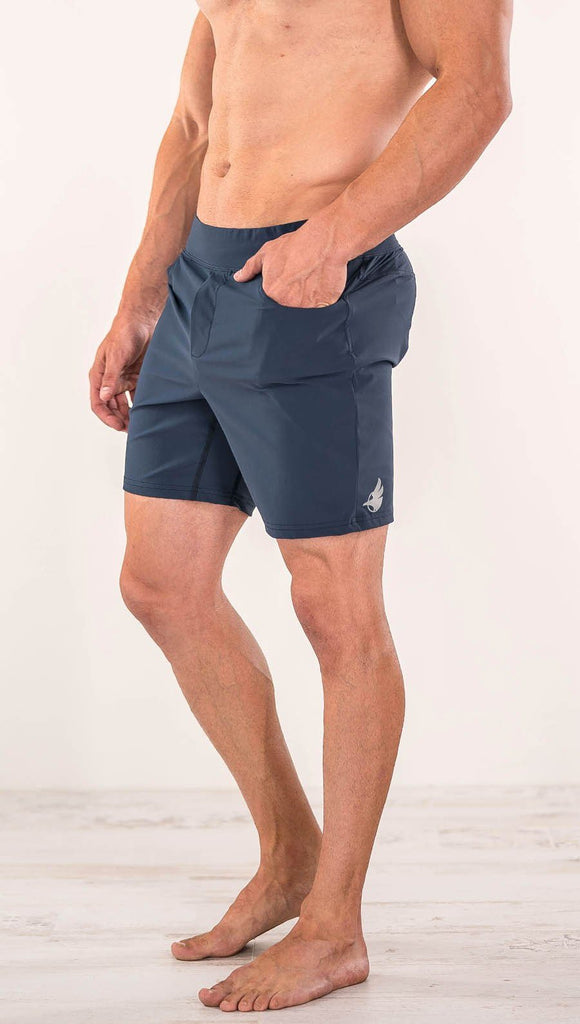 Close up left side view of model wearing black men's performance shorts