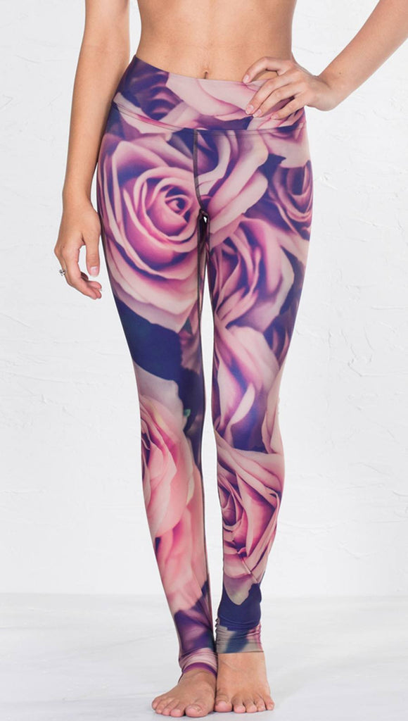 close up front view of model wearing printed full length leggings with all-over rose design motif