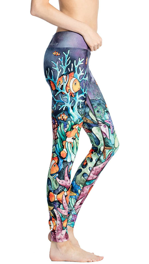 close up right side view of model wearing coral reef themed printed capri leggings