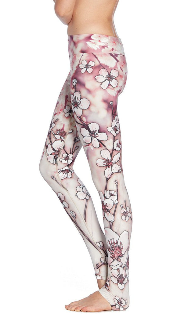 close up side view of model wearing cherry blossom themed printed full length leggings