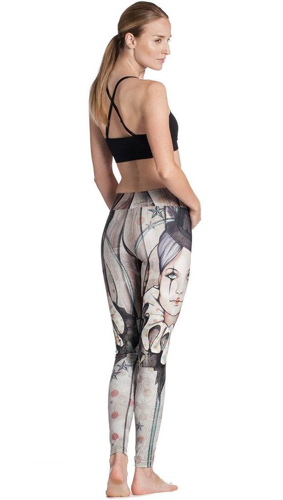 back view of model wearing circus girl themed printed full length leggings and sports top
