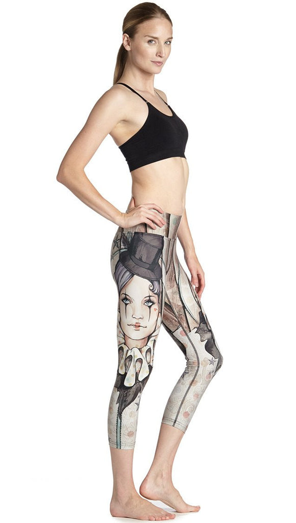 side view of model wearing circus girl themed printed capri leggings