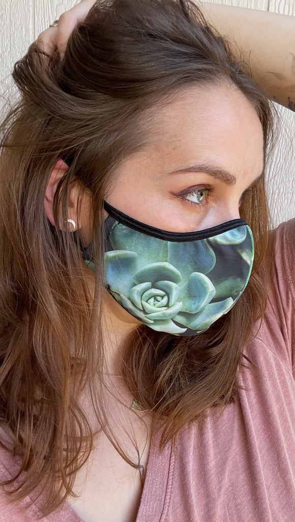 Girl wearing adjustable face mask with green envy succulent-inspired print