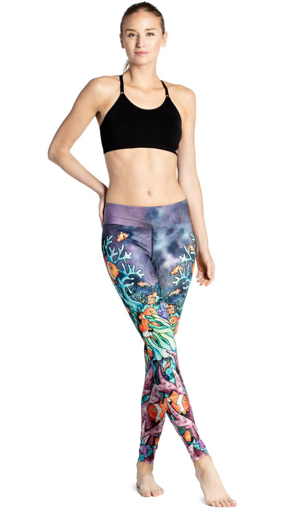 front view of model wearing coral reef themed printed full length leggings