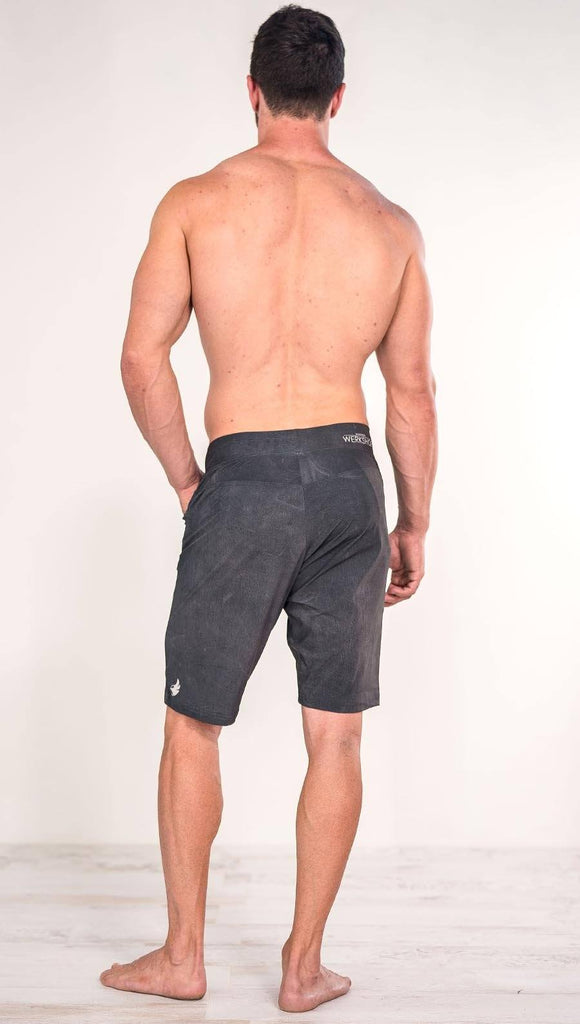 Back view of model wearing gray men's performance shorts
