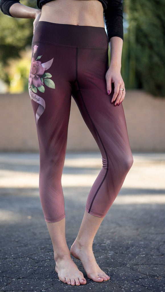 closeup front view of model wearing tattoo rose design printed capri leggings