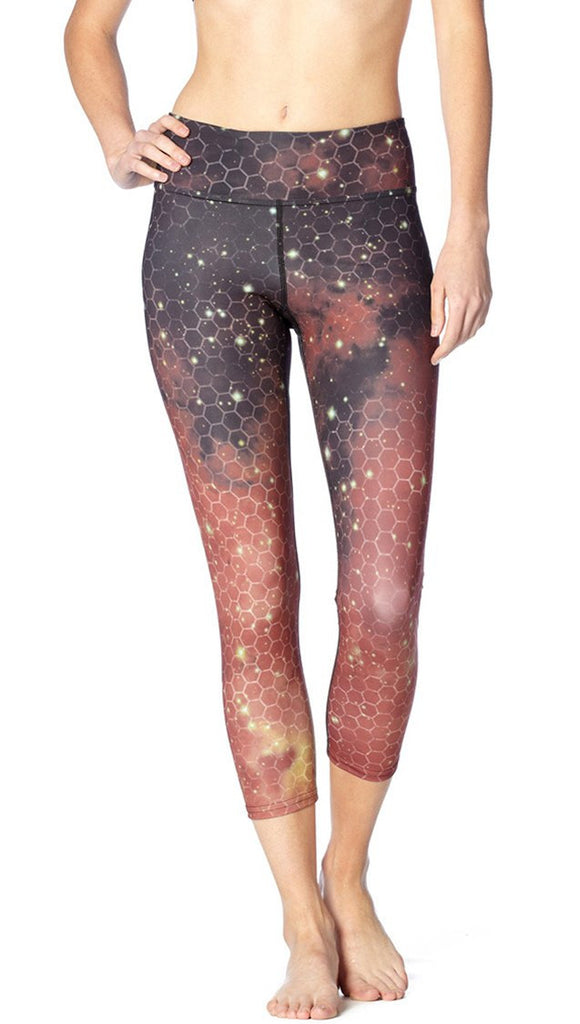  close up front view of model wearing honeycomb galaxy themed printed capri leggings