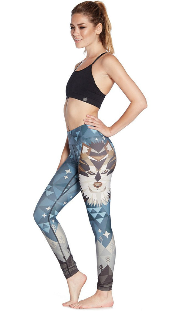 left side view of model wearing wolf / dog themed printed full length leggings