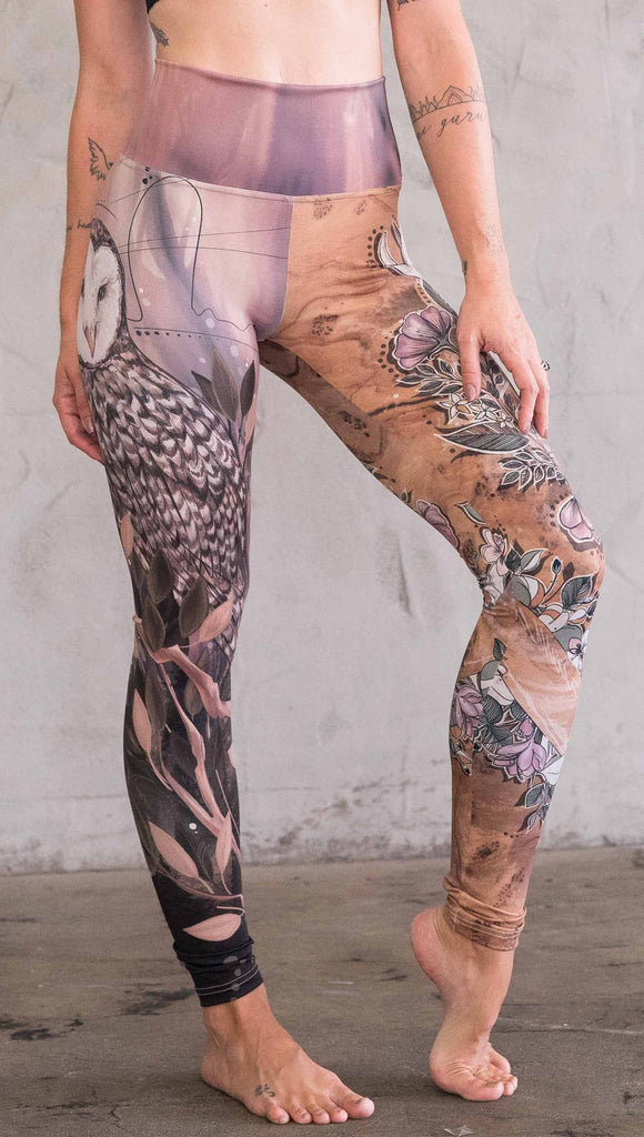 Front view of model wearing the jackalope/ owl mashup leggings in a light mauve and brown color. One leg has an owl and the other leg has a jackalope