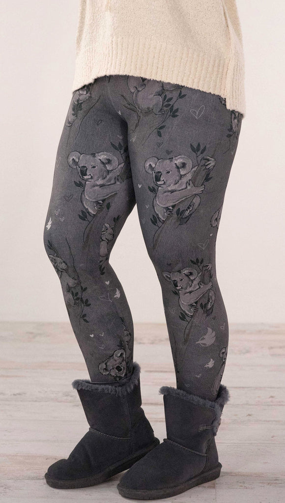 Front view of model wearing koala leggings with branches and leaves