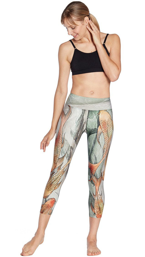 front view of model wearing koi fish themed printed capri leggings
