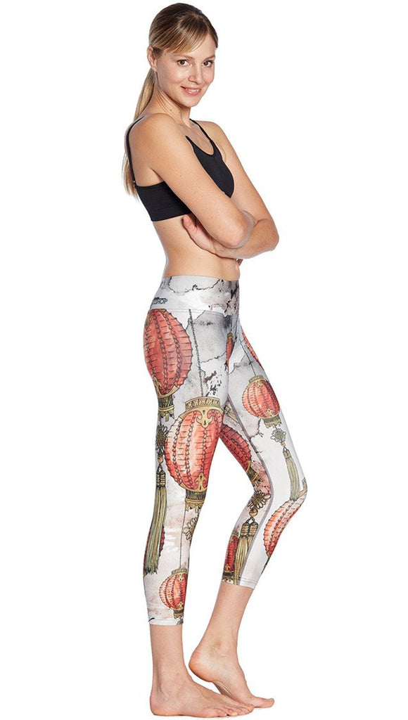 right side view of model wearing Chinese festival lanterns themed printed capri leggings
