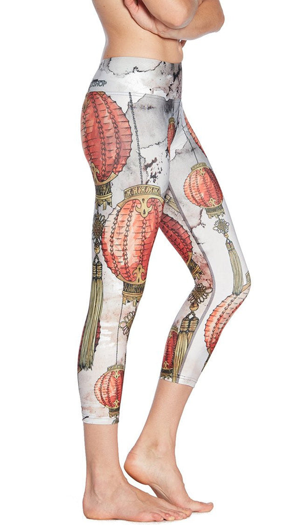 close up right side view of model wearing Chinese festival lanterns themed printed capri leggings