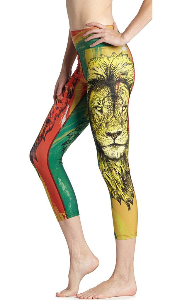 close up left side view of model wearing rasta lion themed printed capri leggings