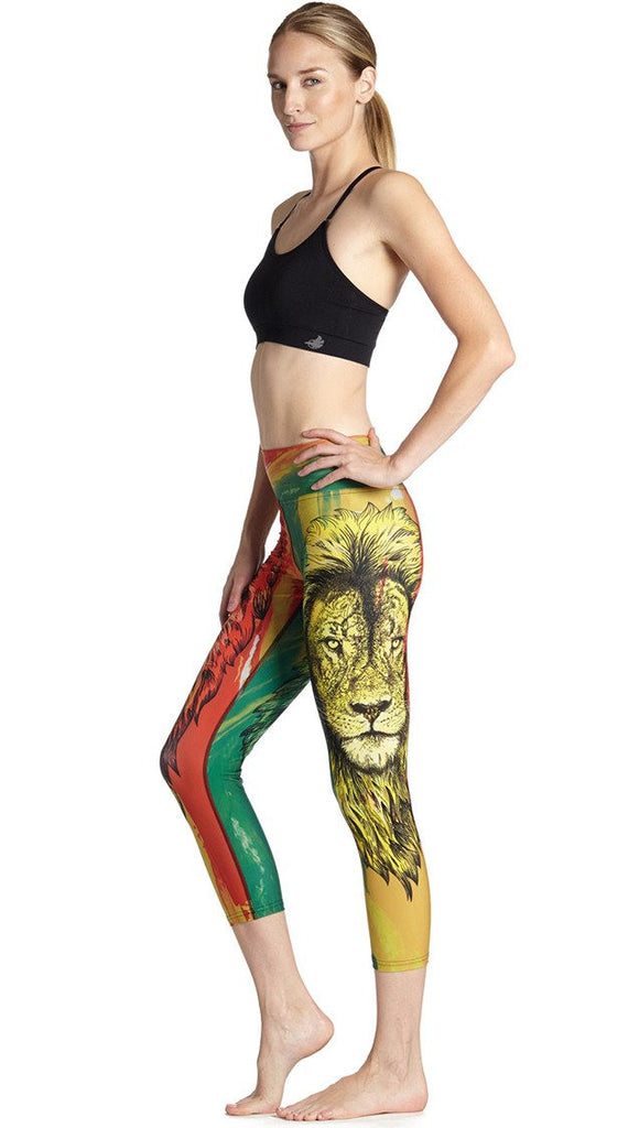 left side view of model wearing rasta lion themed printed capri leggings