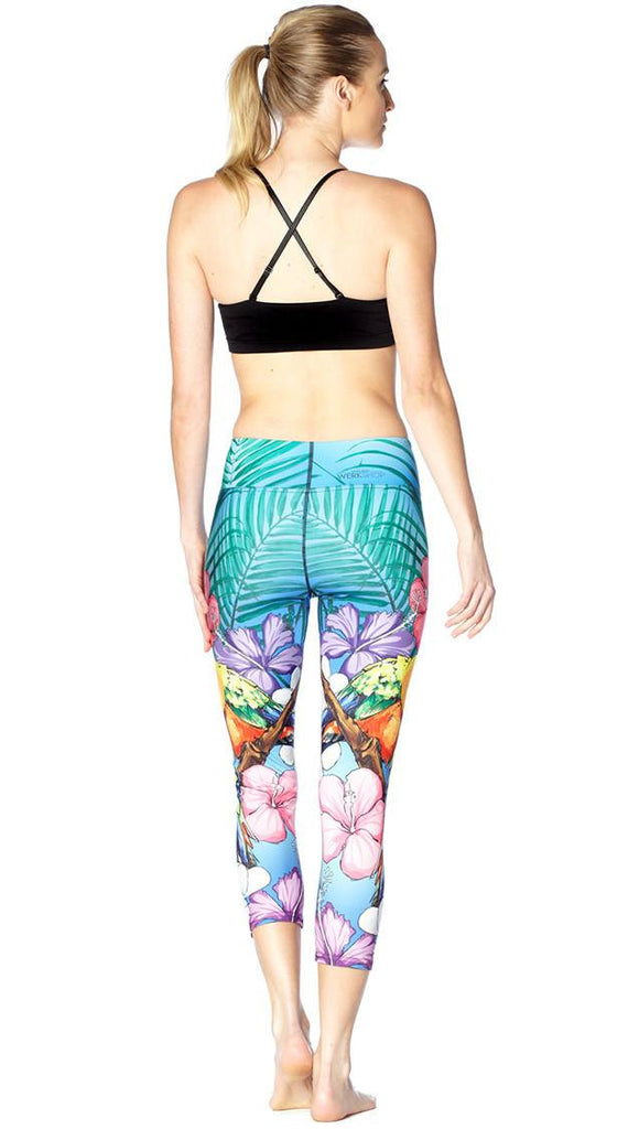 back view of model wearing lovebird themed printed capri leggings