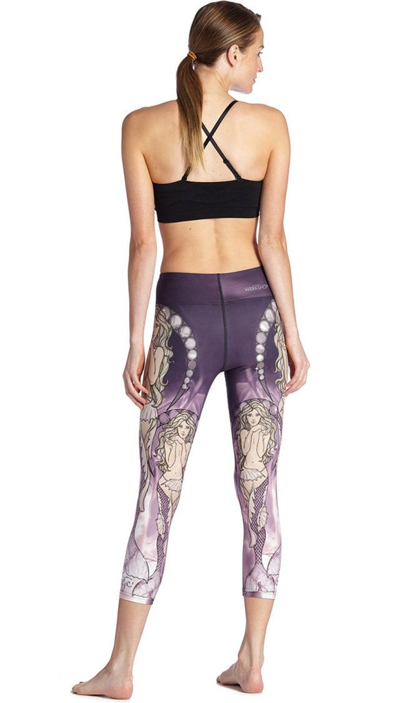 back view of model wearing mermaid themed printed capri leggings