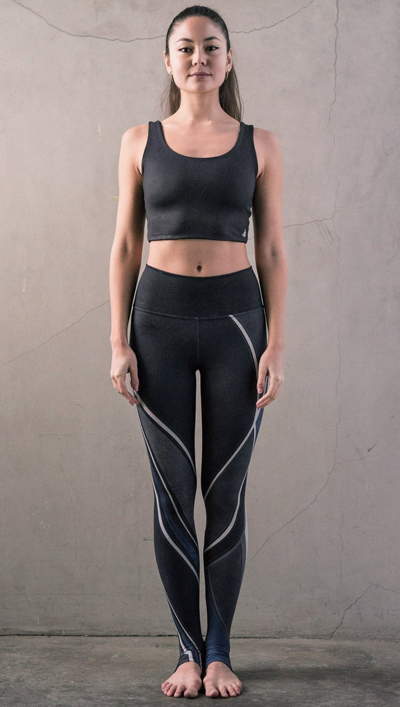front view of model wearing midnight blue colored motocross inspired printed full length leggings