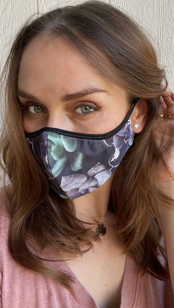 Girl wearing midnight garden adjustable face mask with succulent inspired print - with soft purple and green tones