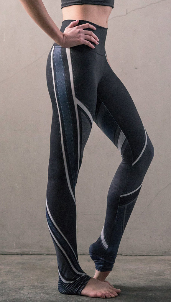 close up right side view of model wearing midnight blue colored motocross inspired printed full length leggings