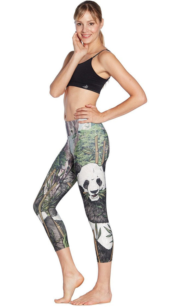 left side view of model wearing panda themed printed capri leggings