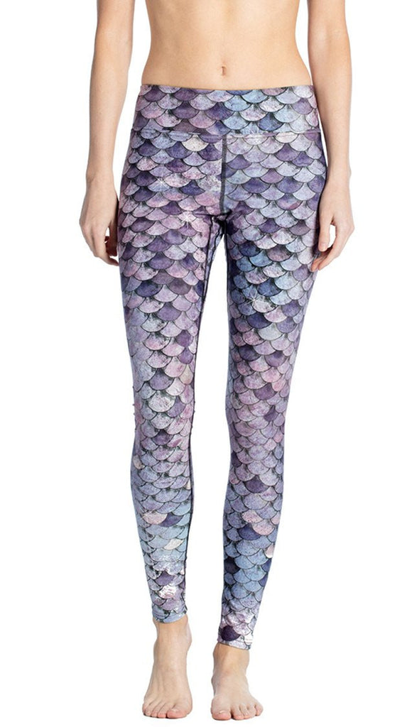 close up front view of model wearing purple mermaid scale themed printed full length leggings