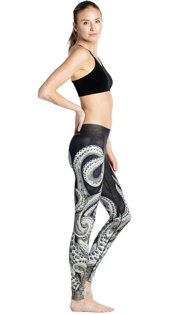 right side view of model wearing black and white tentacle themed printed full length leggings