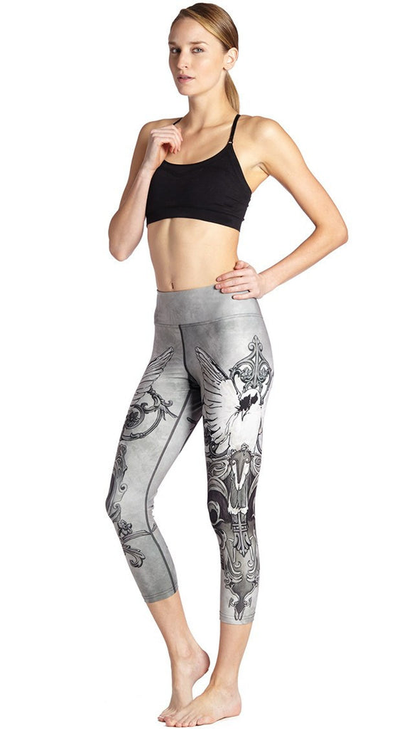 front view of model wearing black and white fantasy dove themed printed capri leggings