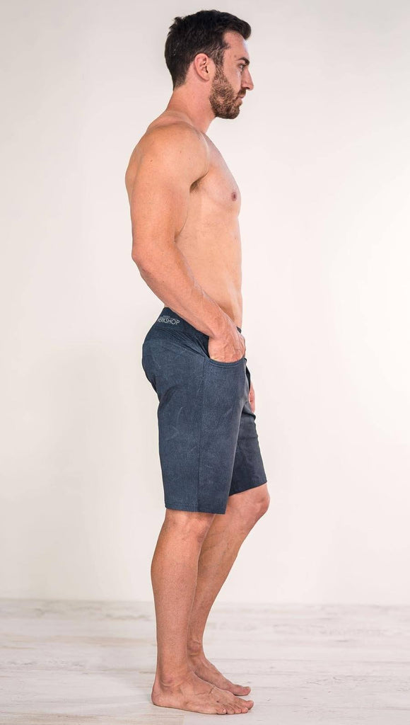Right side view of model wearing slate men's performance shorts