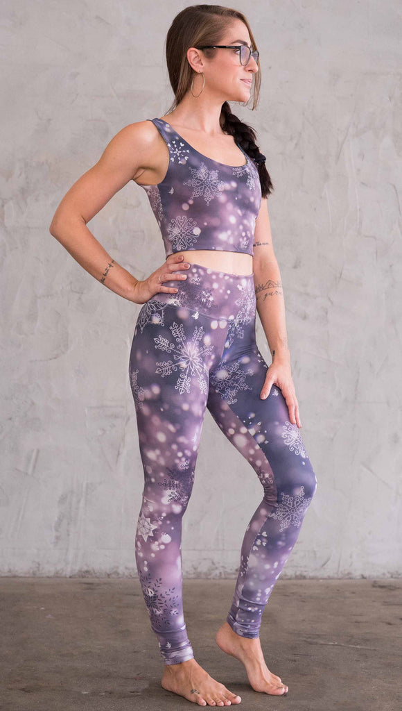 Front right view of model wearing purple leggings with white snowflakes