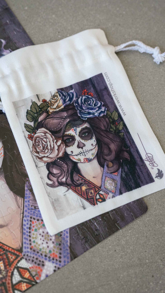 WERKSHOP Sugar Skull Mashup Canvas drawcord pouch (comes free with matching puzzle!). The artwork celebrates Dia De Los Muertos with a drawing of a girl wearing sugarskull makeup surrounded by a wreath of roses.