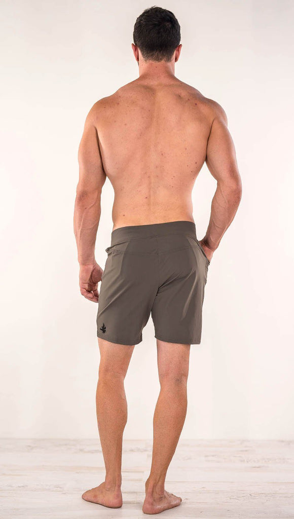 Back side view of model wearing men's taupe performance shorts with slim fit