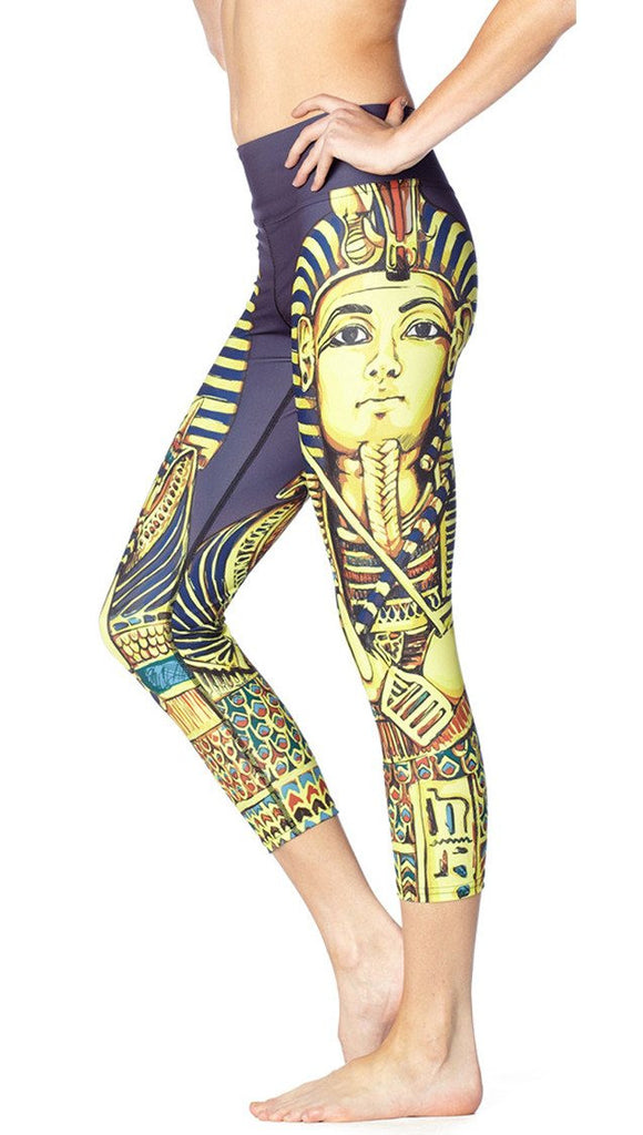close up left side view of model wearing King Tut themed printed capri leggings