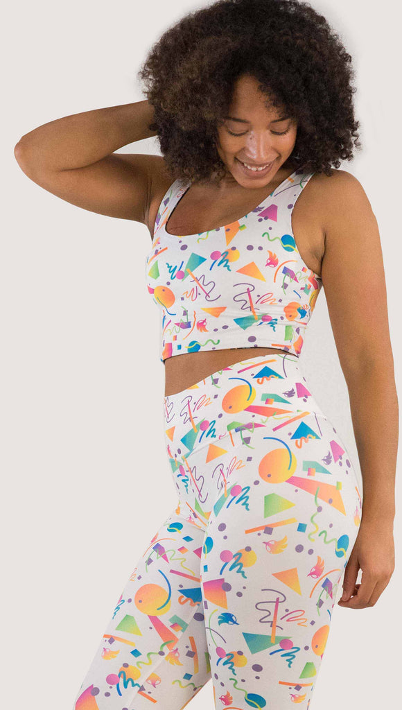 Front view of model wearing WERKSHOP Black and White Confetti Top ... with multi-colored confetti  over a black background on one side and over a white background on the other side. 