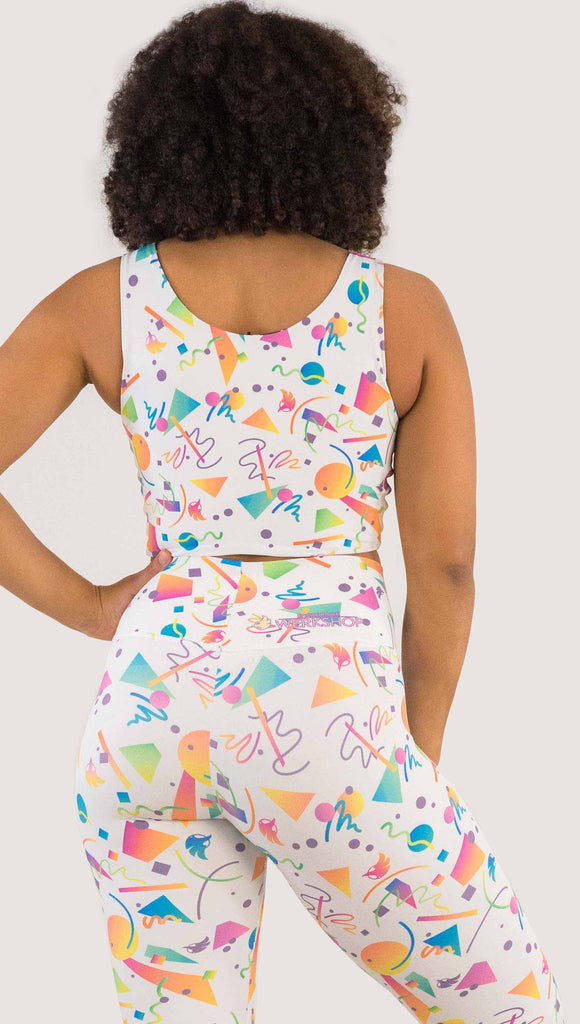 Back view of model wearing WERKSHOP Black and White Confetti Top ... with multi-colored confetti  over a black background on one side and over a white background on the other side. 