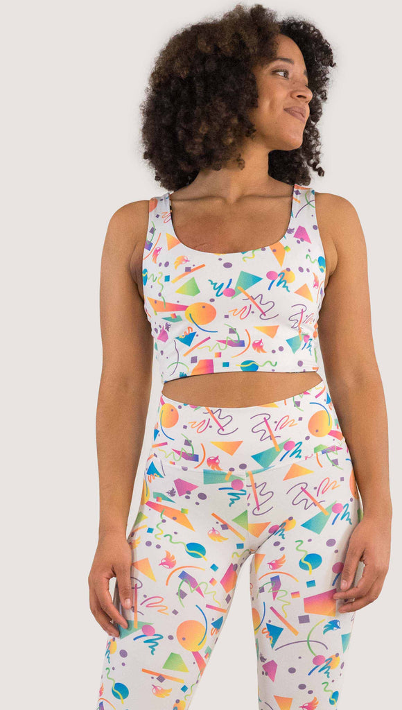 Front view of model wearing WERKSHOP Black and White Confetti Top ... with multi-colored confetti  over a black background on one side and over a white background on the other side. 